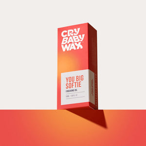 Packaging box for You Big Softie Finishing Oil | Crybaby Wax featuring a red and orange gradient design against a matching background, emphasizing skincare and body care wellness.