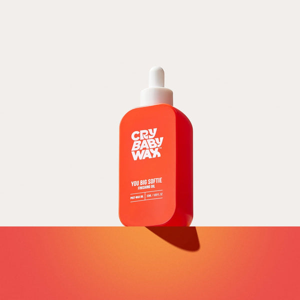 Bright orange bottle of You Big Softie Finishing Oil | Crybaby Wax with white dropper cap, designed for skincare and body care wellness routines.