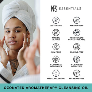 Woman with a towel wrapped around her head applying Ozonated Aromatherapy Cleansing Oil | Kindness Powered Skincare, alongside icons indicating the product is gluten-free, paraben-free, mineral oil-free, PEG-free, non-toxic, silicone-free, free of synthetic ingredients, hormone disruptors, non-comedogenic, and phthalate-free.