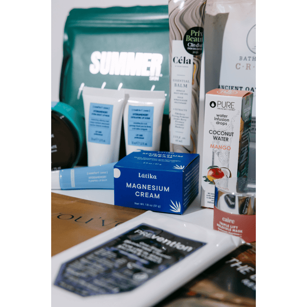 Assorted skincare, wellness supplements, and body care products displayed together, representing the 2026 Wellness Month Box ($1,140+ Value) | Live Love Spa collection.
