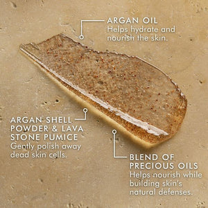 Close-up of a textured exfoliating scrub sample highlighting key ingredients including argan oil for hydration, argan shell powder and lava stone pumice for gentle polishing, and a blend of precious oils to nourish and protect skin, featured in Body Polishing Scrub | Moroccanoil.