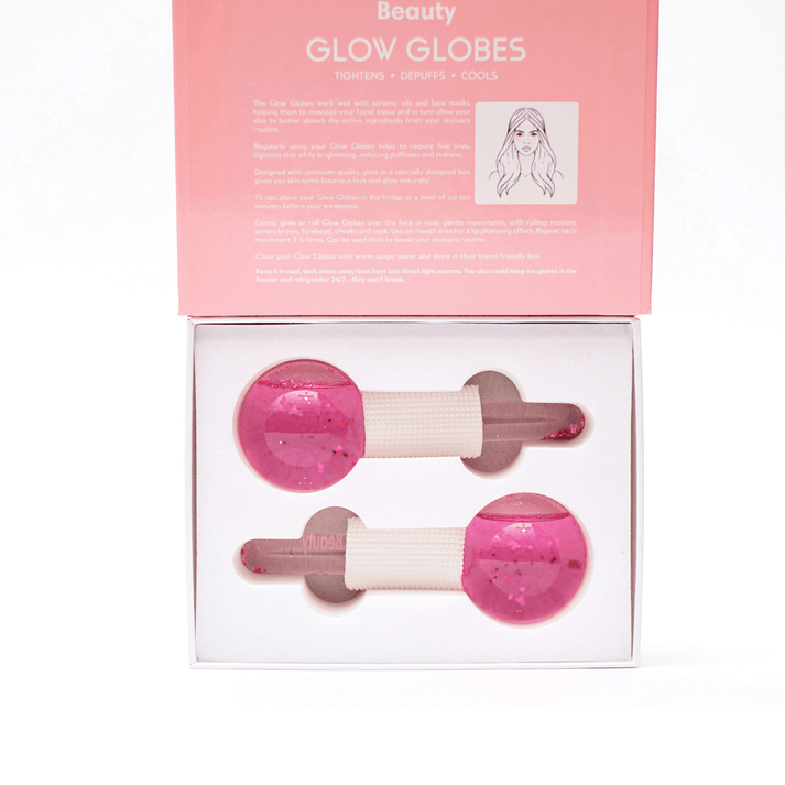 Glow Globes [Ice Roller for Face] | Dreambox Beauty features pink ice rollers designed for skincare to tighten, depuff, and cool the skin for a refreshed look.