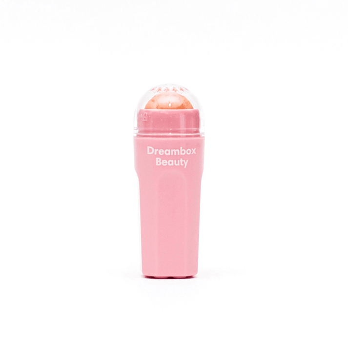 Pink packaging and roller product of Slick Oil Absorbing Volcanic Roller [Removes Oil & Shine] | Dreambox Beauty designed for skincare to reduce oil and shine on the face.