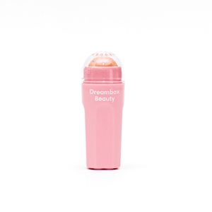 Pink oil absorbing roller with "Dreambox Beauty" branding designed for skincare, featuring Slick Oil Absorbing Volcanic Roller [Removes Oil & Shine] | Dreambox Beauty.