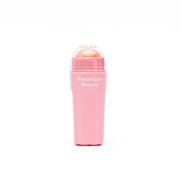 Pink oil absorbing roller with "Dreambox Beauty" branding designed for skincare, featuring Slick Oil Absorbing Volcanic Roller [Removes Oil & Shine] | Dreambox Beauty.