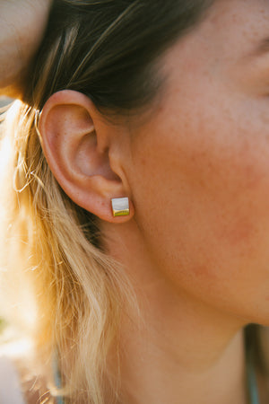 Close-up of a person wearing Gold Dipped Pearl Studs | Meghan Bo Designs, featuring elegant gold-accented square pearl earrings against a natural skin tone.