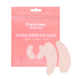 Packaging of Hydrating Reusable Under Eye Patches | Dreambox Beauty in pink with two light beige under eye patches displayed next to it, promoting skincare for smoothing, hydrating, and tightening.
