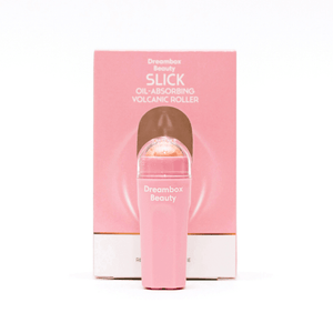 Slick Oil Absorbing Volcanic Roller [Removes Oil & Shine] | Dreambox Beauty in a pink container with a volcanic mineral roller, designed for skincare to reduce shine and absorb oil.