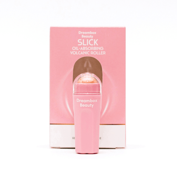 Slick Oil Absorbing Volcanic Roller [Removes Oil & Shine] | Dreambox Beauty in a pink container with a volcanic mineral roller, designed for skincare to reduce shine and absorb oil.