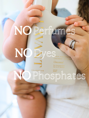 Close-up of a baby and adult holding a white bottle of High Performing Laundry Detergent - Unscented | L'AVANT Collective, highlighting it contains no perfumes, dyes, or phosphates.