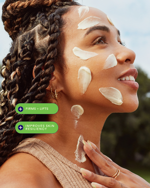 Woman with braided hair applying Firm Believer Goji Stem Cell + Pomegranate Smoothing Neck + Face Cream | Three Ships on her face and neck, showcasing skincare benefits that firm and lift while improving skin resiliency.