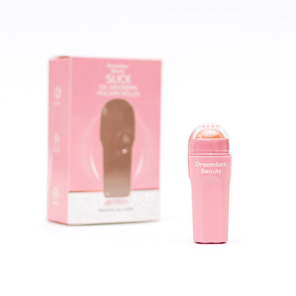 Pink Slick Oil Absorbing Volcanic Roller [Removes Oil & Shine] | Dreambox Beauty with a visible rollerball applicator and matching pink packaging designed for skincare and oil control.