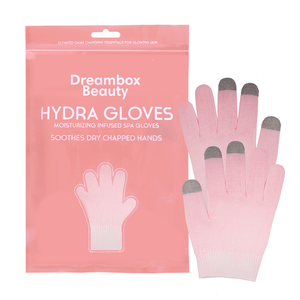 Hydrating Infused Moisturizing Gloves | Dreambox Beauty displayed with soft pink moisturizing gloves featuring touchscreen-compatible fingertips next to matching pink resealable packaging for skincare and body care.