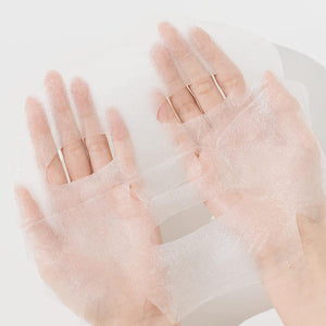 Hands holding a translucent, delicate sheet mask designed for skincare use, representing the ImPHYTO Mucin | Leaders product for soothing and hydrating skin.