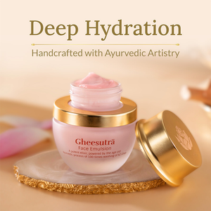 Open container of Gheesutra Face Emulsion | Shankara showing soft pink cream, placed on a decorative natural stone with gold lid beside it, promoting deep hydration and Ayurvedic skincare.