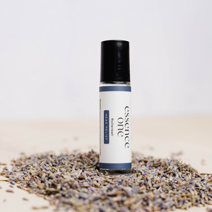 Head Relief Rollerball - Tension Support | Essence One wellness device with a rollerball applicator, surrounded by dried lavender for soothing and tension relief.
