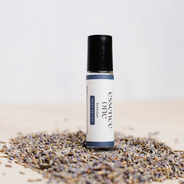 Head Relief Rollerball - Tension Support | Essence One wellness device with a rollerball applicator, surrounded by dried lavender for soothing and tension relief.