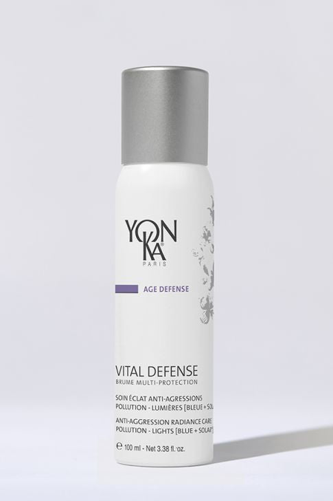 White bottle of Vital Defense Mist | Yon-Ka Paris skincare product with silver cap, designed for anti-aggression radiance care and pollution protection, displayed on light background.