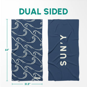 Waffle Microfiber Beach Towel - Curl | SUN'Y showing dual-sided design with navy blue wave pattern on one side and solid navy blue with SUN'Y logo on the other side.