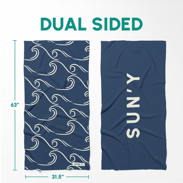 Waffle Microfiber Beach Towel - Curl | SUN'Y showing dual-sided design with navy blue wave pattern on one side and solid navy blue with SUN'Y logo on the other side.