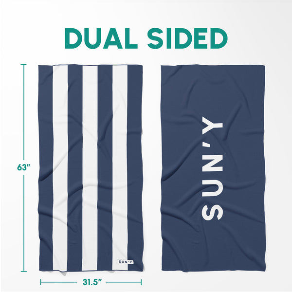 Waffle Microfiber Beach Towel - Nautical Navy | SUN'Y showing dual-sided design with navy and white stripes on one side and solid navy with brand name on the other.