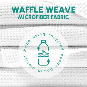 Close-up of stacked white waffle weave microfiber fabric with text highlighting recycled ocean-bound plastic material for the Waffle Microfiber Beach Towel - Boho | SUN'Y.
