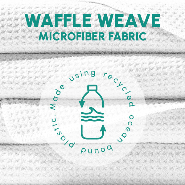 Close-up of stacked white waffle weave microfiber fabric with text highlighting recycled ocean-bound plastic material for the Waffle Microfiber Beach Towel - Boho | SUN'Y.