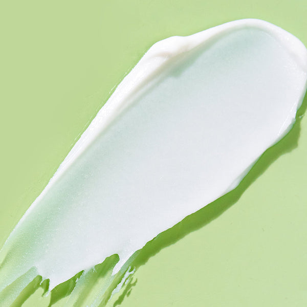 Smooth, creamy texture of BIOME+ smoothing cloud crème | IMAGE Skincare spread on a light green background, highlighting its skincare and body care benefits.