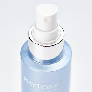 Close-up of a spray bottle featuring the skincare product Marine Mist | Phytomer with a white nozzle and light blue container, perfect for refreshing skincare routines.