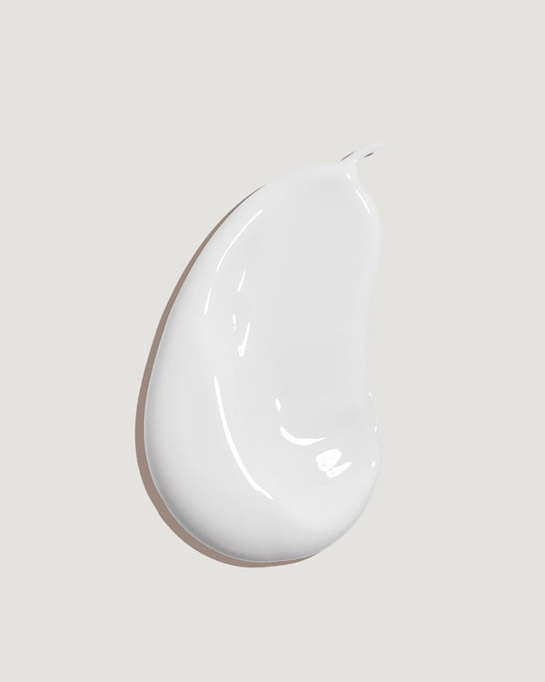 Smooth white lotion texture sample representing Peach Blossom Classic Body Sunscreen Lotion SPF 70 | COOLA skincare product for body care and protection.