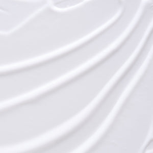 Close-up of smooth white lotion texture with gentle swirls, representing the Hydramemory Body Lotion | [ comfort zone ] skincare product for moisturizing and body care.