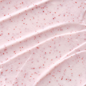 Close-up texture of a creamy pink exfoliating lip scrub with small red exfoliating beads, showcasing Hydramemory Exfoliating Lip Scrub | [ comfort zone ] for skincare use.
