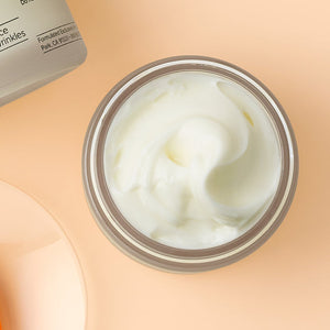 Open jar of creamy white skincare product on beige background, showcasing texture of Feel Better™ Hyaluronic Acid Moisturizing Cream | ClarityRx for hydration and skincare.