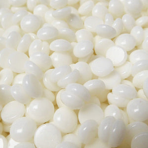 Close-up of smooth, creamy white vegan hard wax pellets used for gentle skincare with I'm Sensitive Meltdown Vegan Hard Wax | Crybaby Wax by Live Love Spa.