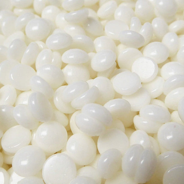 Close-up of smooth, creamy white vegan hard wax pellets used for gentle skincare with I'm Sensitive Meltdown Vegan Hard Wax | Crybaby Wax by Live Love Spa.
