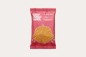 Red packaging of Full On Meltdown Vegan Hard Wax | Crybaby Wax showing small yellow wax pellets inside and branding text on front for skincare and body care use.