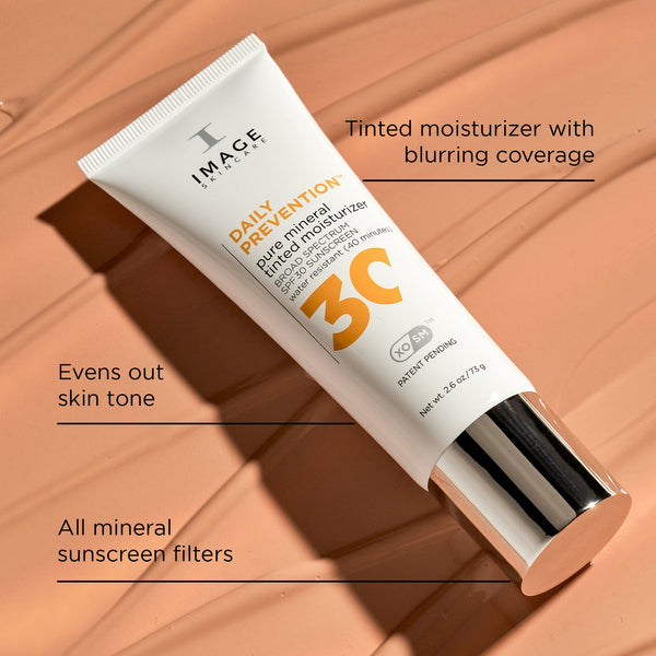 Tube of DAILY PREVENTION pure mineral tinted moisturizer SPF 30 | IMAGE Skincare with all mineral sunscreen filters, tinted coverage that blurs imperfections, and evens out skin tone on a soft peach background.
