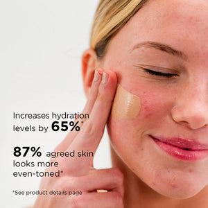 Close-up of a woman applying DAILY PREVENTION pure mineral tinted moisturizer SPF 30 | IMAGE Skincare on her cheek, highlighting improved hydration and even-toned skin benefits.