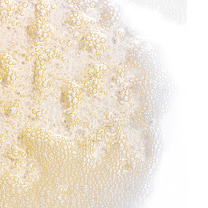 Close-up view of foamy, golden bubbles from Deep Pore Cleanser Normal/Combination Skin | Skin Fitness Therapy, highlighting its rich, cleansing texture for skincare.