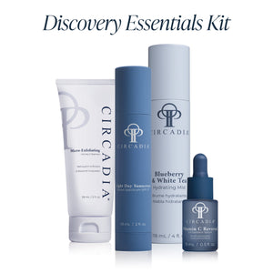 Four skincare products including cleanser, sunscreen, hydrating mist, and vitamin C serum from the Discovery Essentials Kit | Circadia displayed against a white background.