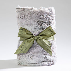 Spa Heat Wrap | Sonoma Lavender wrapped in a soft, plush silver-gray fabric with a green ribbon tied in a bow, designed for soothing body care and wellness recovery.