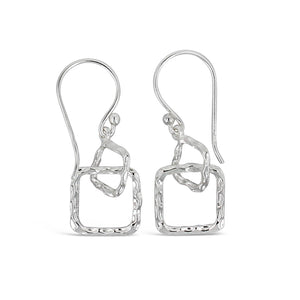 Pair of silver-tone metal drop earrings featuring a textured square and irregular open shapes, minimalist and modern design, Geometry Squares Earrings | Little Sparkles.