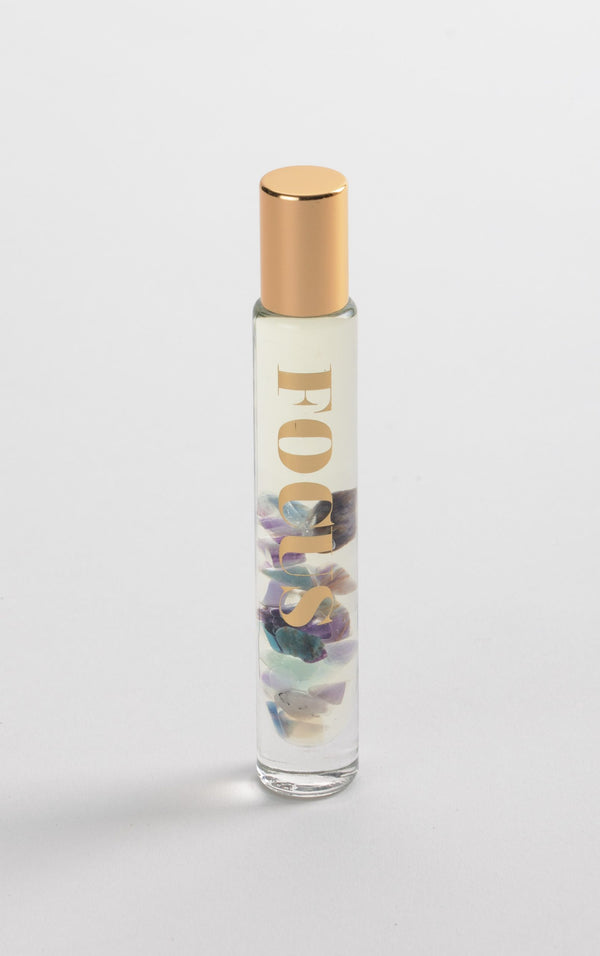 Focus Rollerball | Aluminate Life with clear glass bottle, gold cap, containing a blend of colorful stones inside, designed for skincare and wellness use.