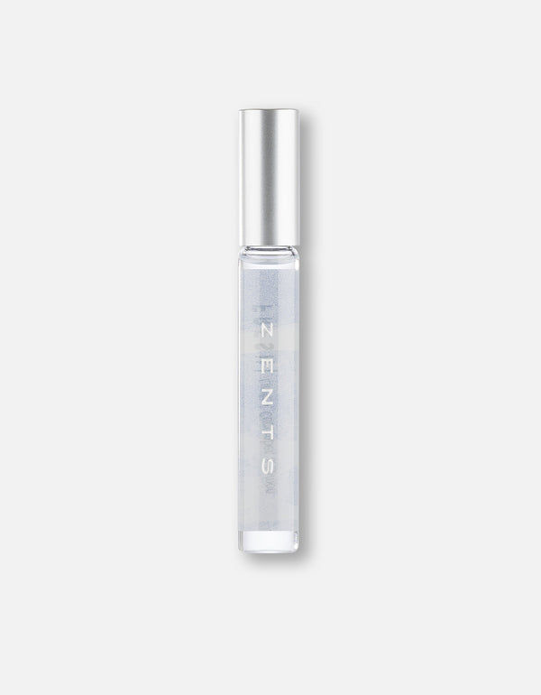 Clear cylindrical roll-on bottle with silver cap containing fragrance oil, labeled Attar Roll-on Scent | Zents, ideal for personal body care and wellness use.