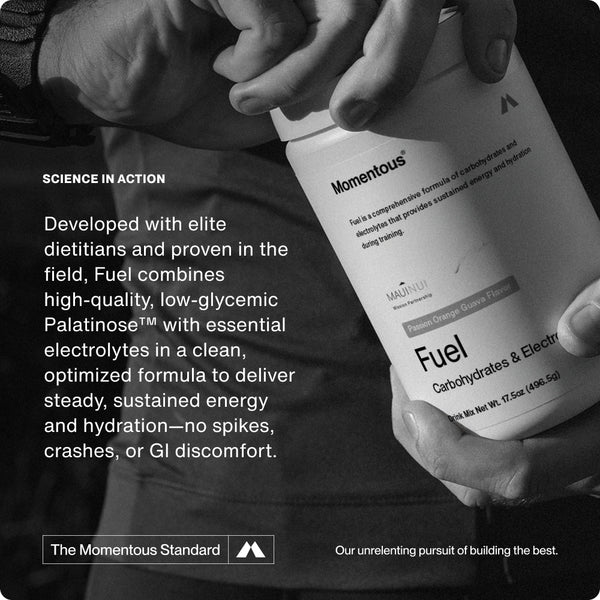 Close-up of a person holding a white bottle labeled Fuel, a carbohydrate and electrolyte formula designed to deliver steady, sustained energy and hydration without spikes or discomfort.