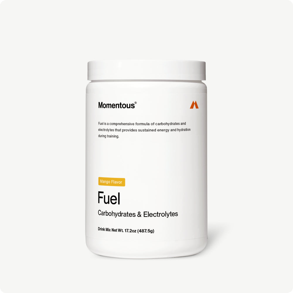 White container of Fuel drink mix with passion orange guava flavor, labeled for carbohydrates and electrolytes to support sustained energy and hydration during training