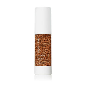 Clear pump bottle of HydroPure™ Tinted Serum with Hyaluronic Acid & CoQ10 | Jane Iredale showing tinted serum with small brown beads inside for skincare and wellness.