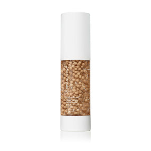 HydroPure™ Tinted Serum with Hyaluronic Acid & CoQ10 | Jane Iredale in a clear bottle with white cap, showing beige tint serum beads, highlighting skincare benefits for hydration and radiance.
