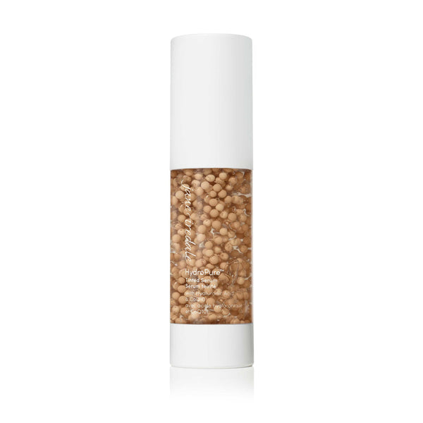 HydroPure™ Tinted Serum with Hyaluronic Acid & CoQ10 | Jane Iredale in a clear bottle with white cap, showing beige tint serum beads, highlighting skincare benefits for hydration and radiance.