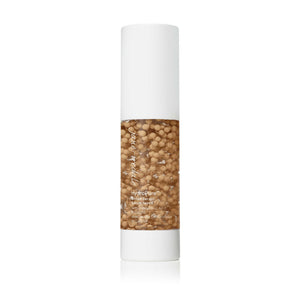 Bottle of HydroPure™ Tinted Serum with Hyaluronic Acid & CoQ10 | Jane Iredale featuring a clear container with visible tinted serum capsules inside and a white pump dispenser, displayed against a white background.